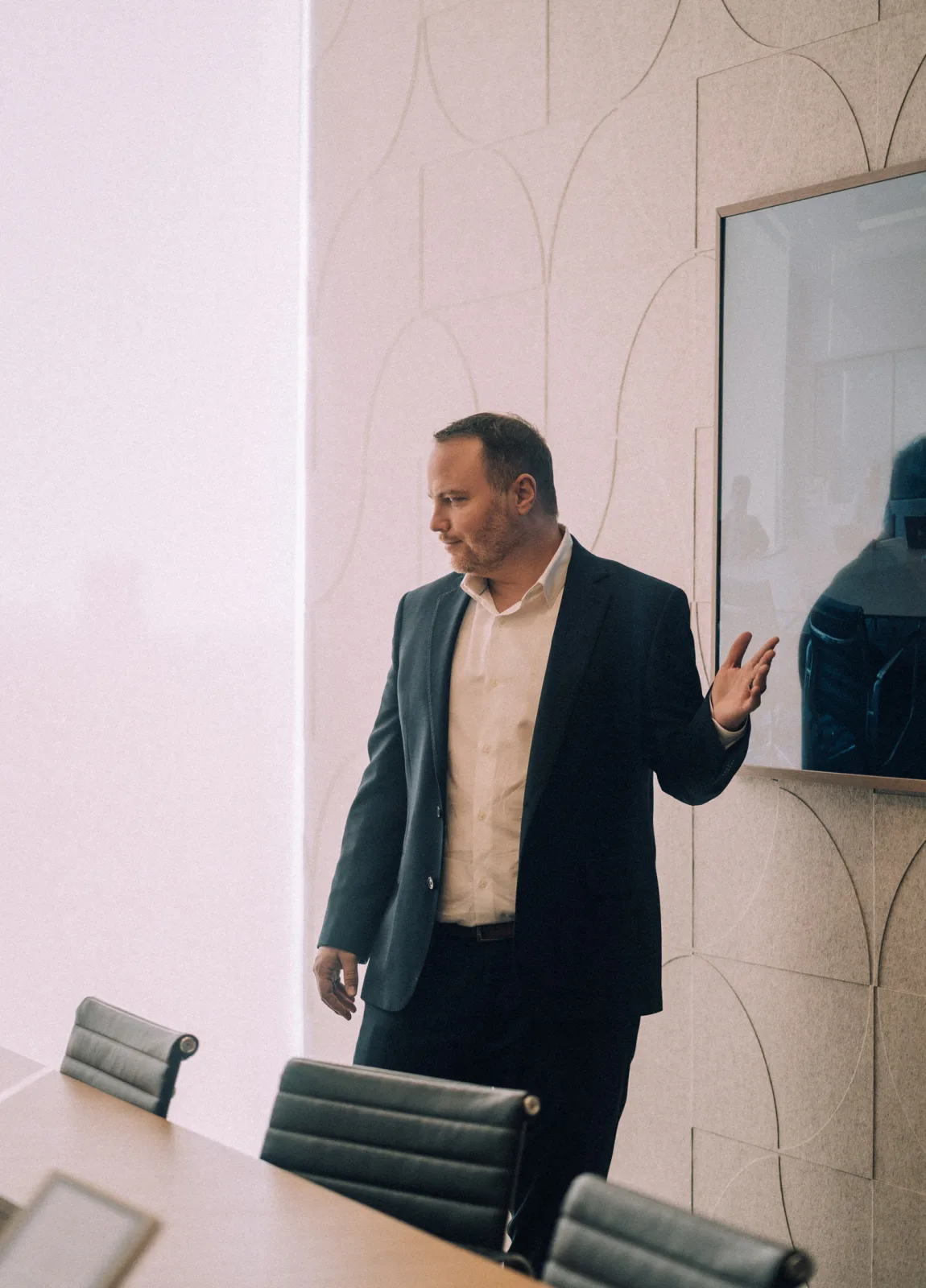 Erik Salazar standing in a conference room